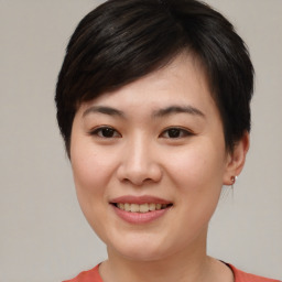 Joyful asian young-adult female with short  brown hair and brown eyes