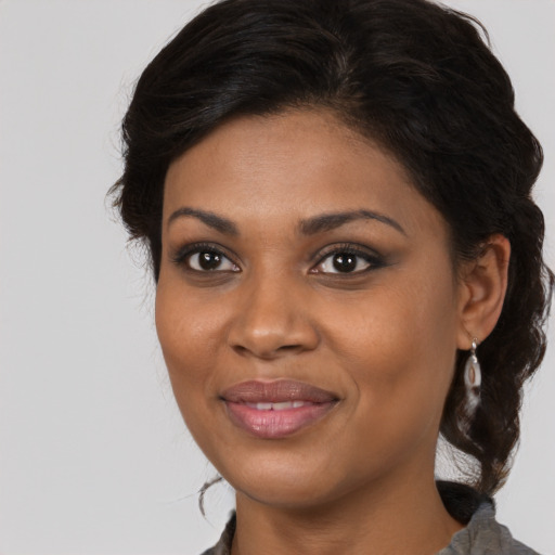 Joyful black young-adult female with medium  brown hair and brown eyes
