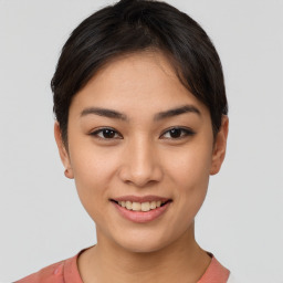 Joyful asian young-adult female with short  brown hair and brown eyes