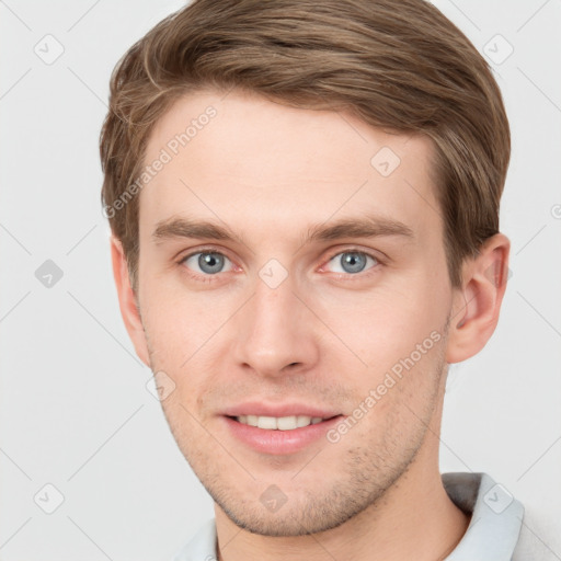 Joyful white young-adult male with short  brown hair and grey eyes