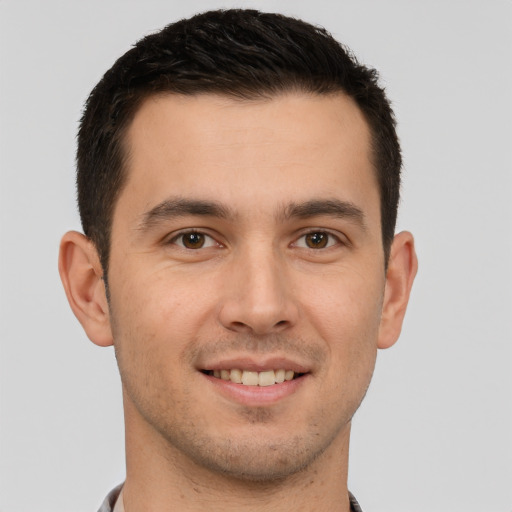 Joyful white young-adult male with short  brown hair and brown eyes