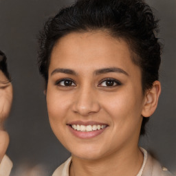 Joyful latino young-adult female with short  brown hair and brown eyes