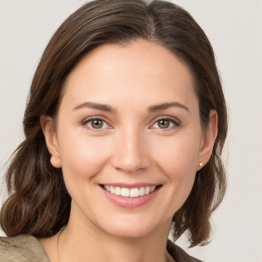 Joyful white young-adult female with medium  brown hair and brown eyes