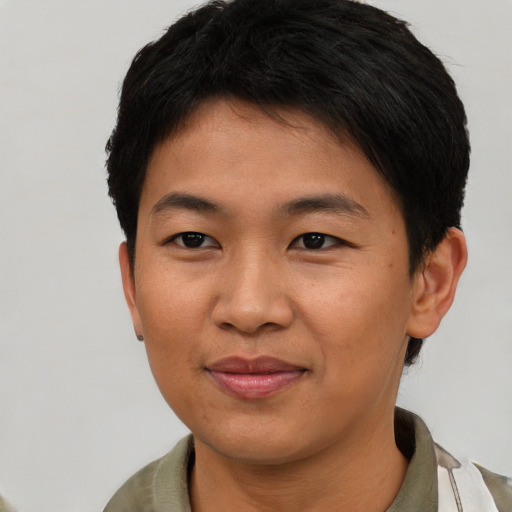 Joyful asian young-adult male with short  brown hair and brown eyes