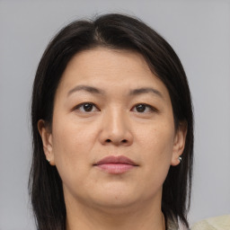 Joyful asian adult female with medium  brown hair and brown eyes