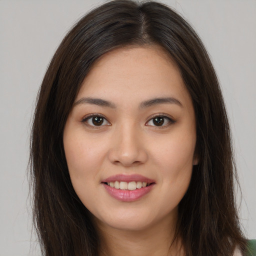 Joyful white young-adult female with long  brown hair and brown eyes