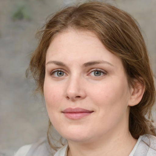 Joyful white young-adult female with medium  brown hair and blue eyes