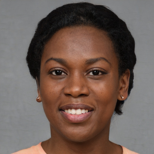 Joyful black young-adult female with short  black hair and brown eyes
