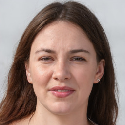 Joyful white adult female with long  brown hair and brown eyes