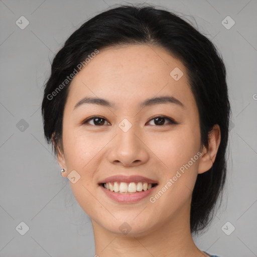 Joyful asian young-adult female with medium  black hair and brown eyes