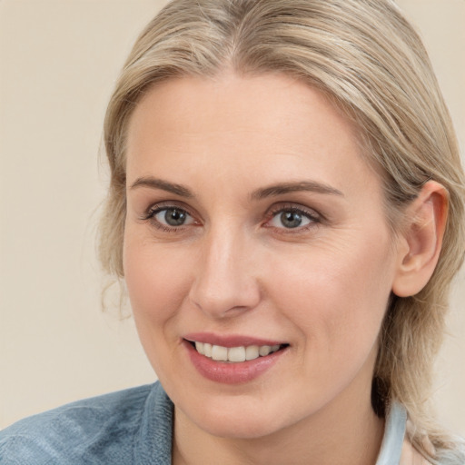 Joyful white young-adult female with medium  brown hair and blue eyes