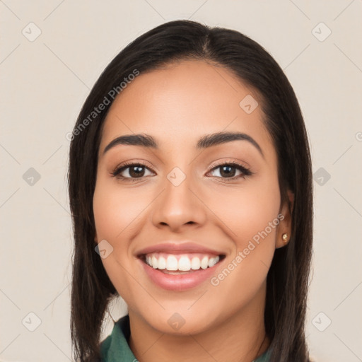 Joyful latino young-adult female with long  brown hair and brown eyes