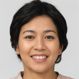 Joyful asian young-adult female with medium  brown hair and brown eyes