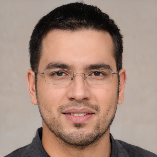 Joyful white young-adult male with short  black hair and brown eyes