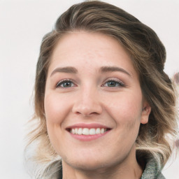 Joyful white young-adult female with medium  brown hair and blue eyes