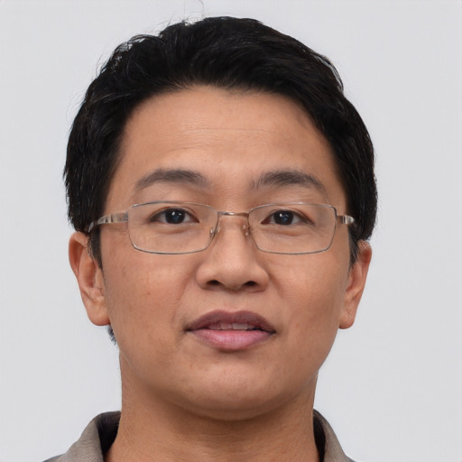 Joyful asian adult male with short  brown hair and brown eyes