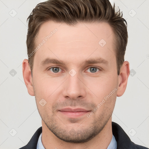 Joyful white young-adult male with short  brown hair and grey eyes