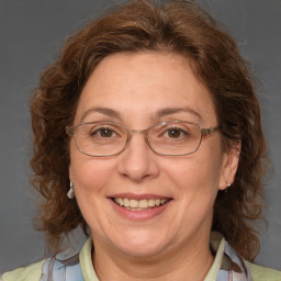 Joyful white middle-aged female with medium  brown hair and brown eyes