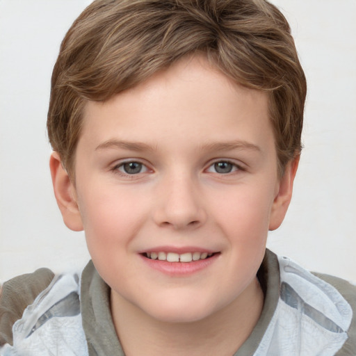 Joyful white child male with short  brown hair and grey eyes