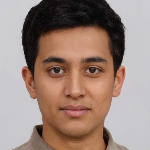 Joyful latino young-adult male with short  brown hair and brown eyes