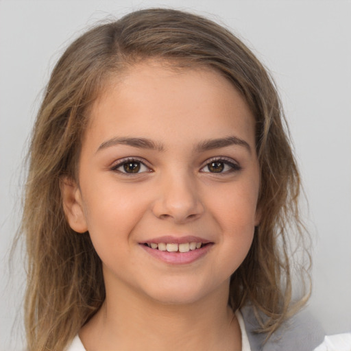 Joyful white child female with medium  brown hair and brown eyes