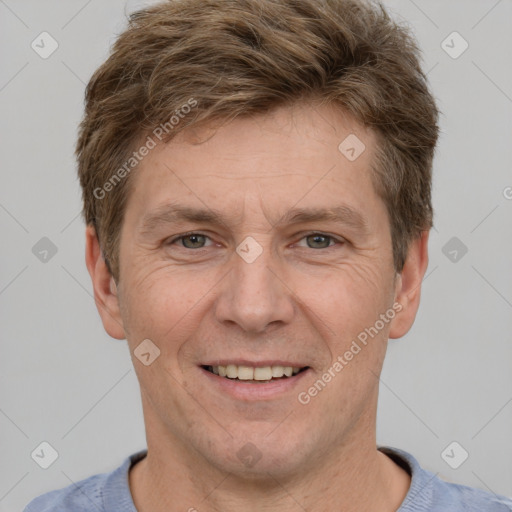 Joyful white adult male with short  brown hair and grey eyes