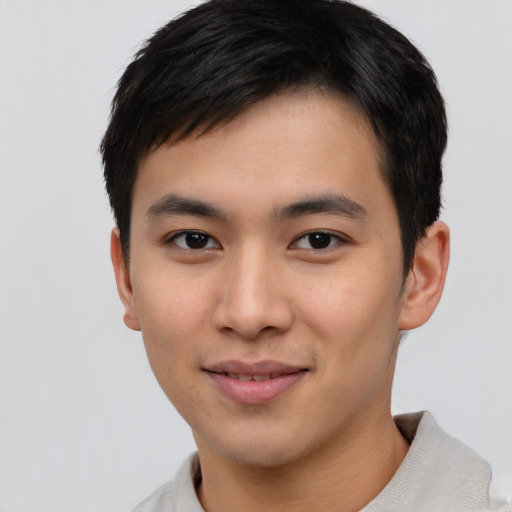 Joyful asian young-adult male with short  black hair and brown eyes