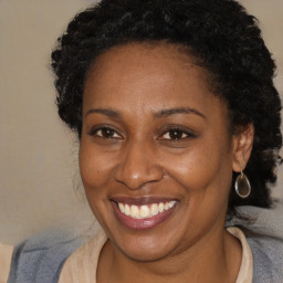 Joyful black adult female with short  brown hair and brown eyes