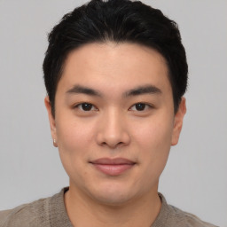 Joyful asian young-adult male with short  black hair and brown eyes