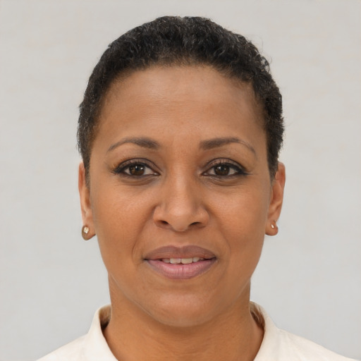 Joyful latino adult female with short  brown hair and brown eyes