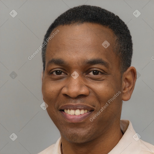 Joyful black young-adult male with short  black hair and brown eyes