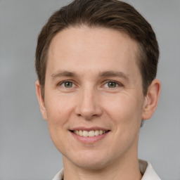 Joyful white adult male with short  brown hair and grey eyes