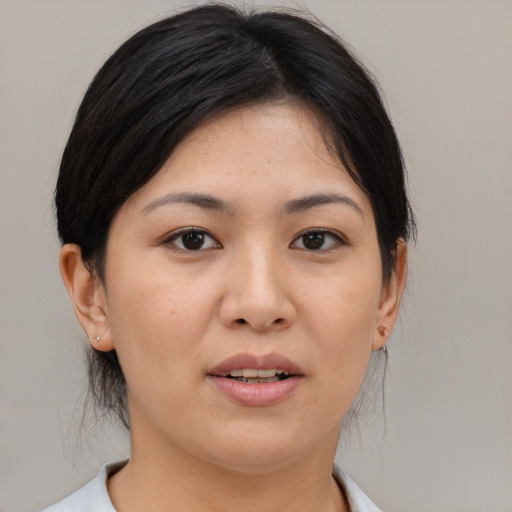Joyful asian young-adult female with medium  black hair and brown eyes