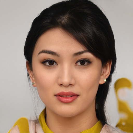 Joyful asian young-adult female with medium  black hair and brown eyes
