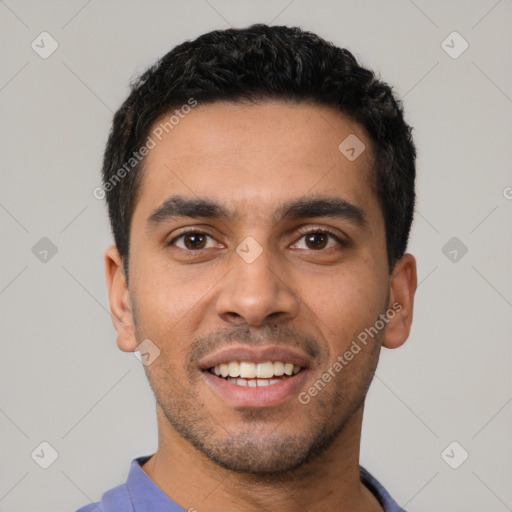 Joyful latino young-adult male with short  black hair and brown eyes