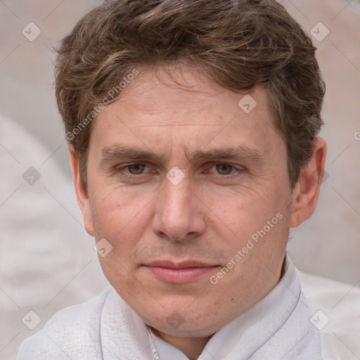 Joyful white adult male with short  brown hair and grey eyes