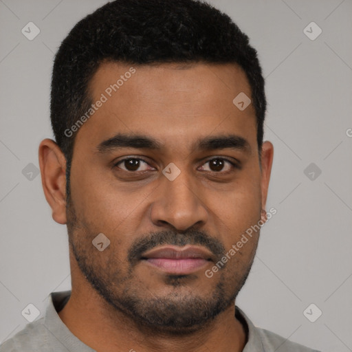 Joyful black young-adult male with short  black hair and brown eyes