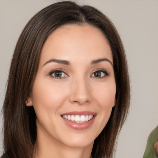 Joyful white young-adult female with medium  brown hair and brown eyes