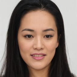 Joyful asian young-adult female with long  brown hair and brown eyes