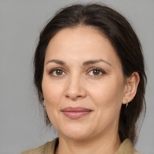 Joyful white adult female with medium  brown hair and brown eyes