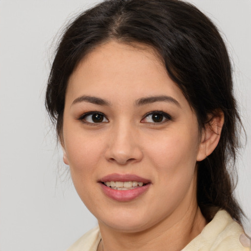 Joyful latino young-adult female with medium  brown hair and brown eyes