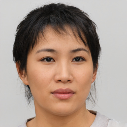 Neutral asian young-adult female with medium  brown hair and brown eyes