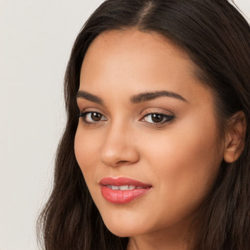 Joyful latino young-adult female with long  brown hair and brown eyes