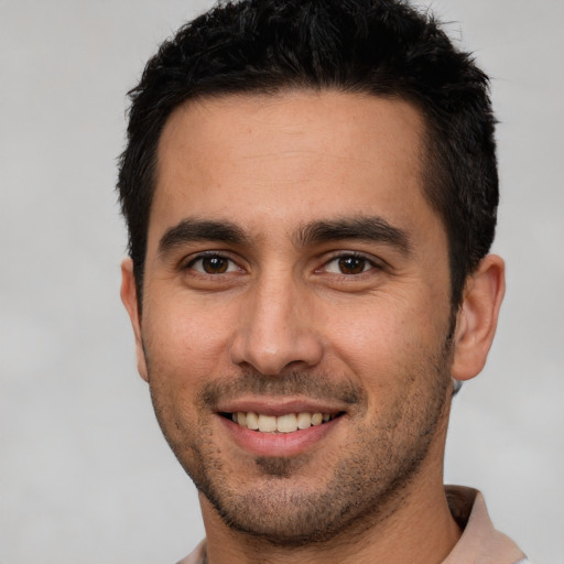 Joyful white young-adult male with short  black hair and brown eyes