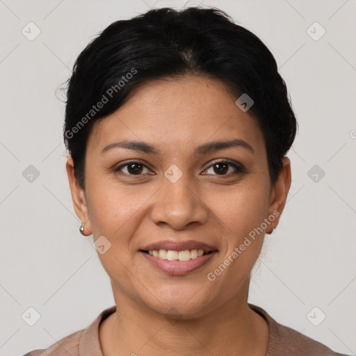 Joyful latino young-adult female with short  black hair and brown eyes