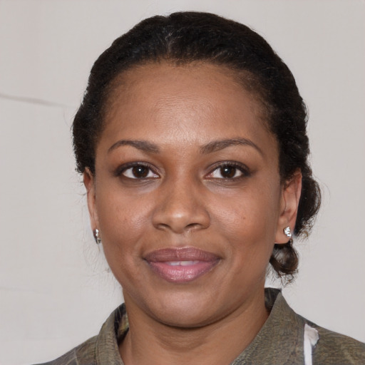 Joyful black adult female with short  brown hair and brown eyes