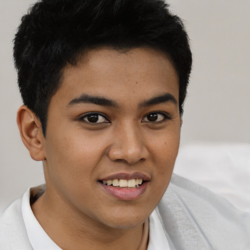 Joyful latino young-adult male with short  brown hair and brown eyes