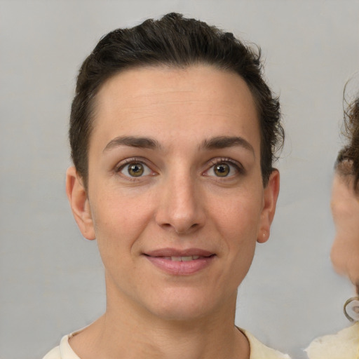 Joyful white young-adult female with short  brown hair and brown eyes