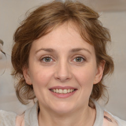 Joyful white young-adult female with medium  brown hair and blue eyes