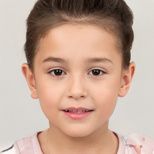 Joyful white child female with short  brown hair and brown eyes